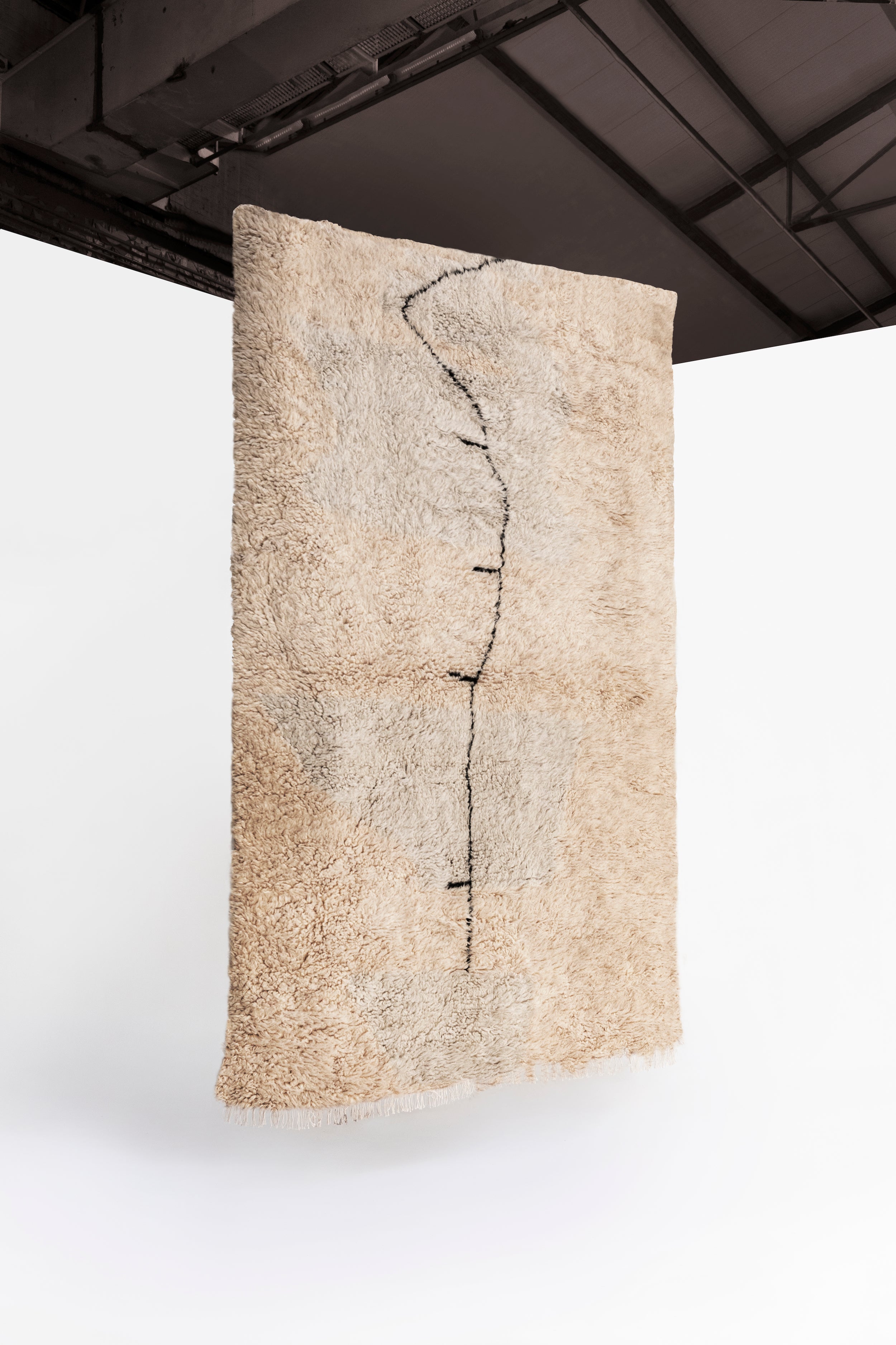 Calvin Pausania's picture of the E la nave va rug, our sustainable handmade artist rug made of 100% sheep wool